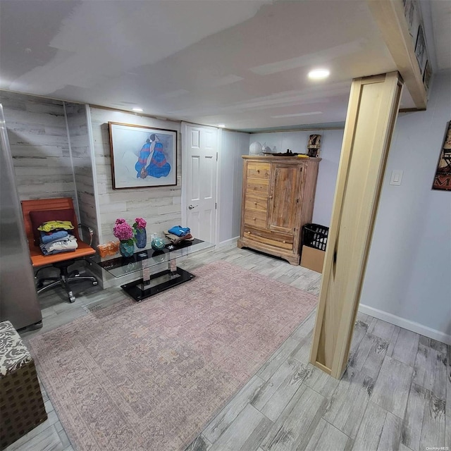 interior space with wood walls and light hardwood / wood-style floors