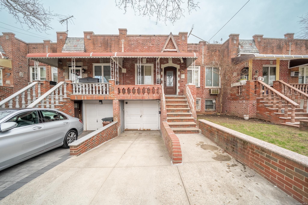 1397 E 52nd St, Brooklyn, NY 11234 - townhome / multi-family property with brick siding, driveway, a garage, and a wall mounted AC