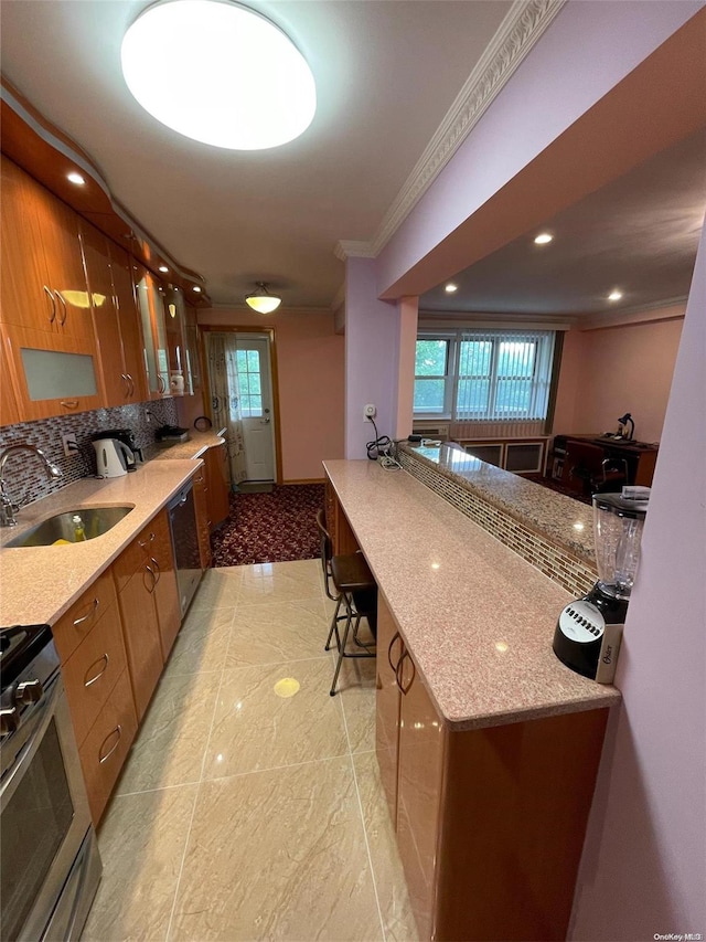 kitchen with a healthy amount of sunlight, light stone countertops, sink, and stainless steel gas range