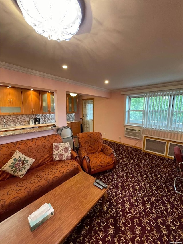 carpeted living room featuring a chandelier, ornamental molding, and sink