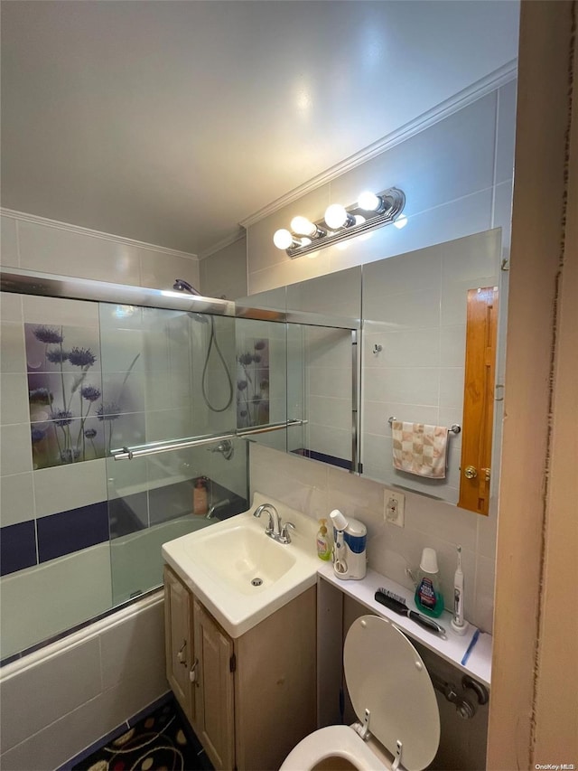 full bathroom with tasteful backsplash, enclosed tub / shower combo, toilet, vanity, and ornamental molding