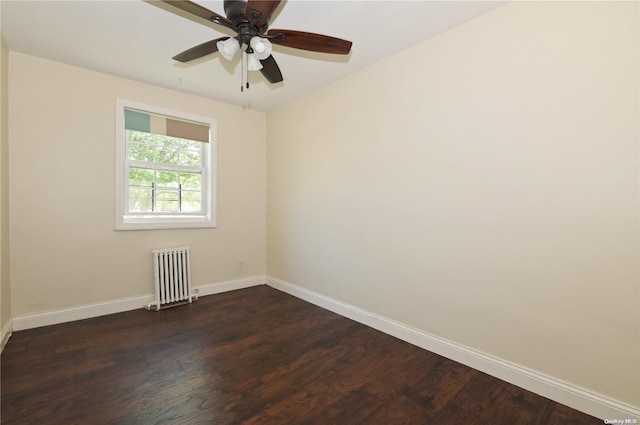 spare room with dark wood-type flooring and radiator heating unit