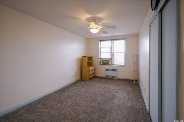 carpeted empty room with ceiling fan, cooling unit, and radiator