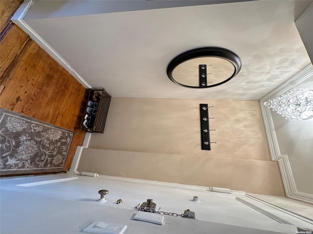 interior space featuring wood walls, lofted ceiling, and ornamental molding