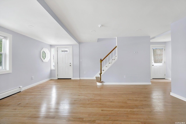 entryway featuring a baseboard heating unit and light wood-type flooring