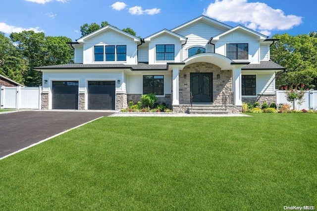 view of front of property featuring a garage and a front lawn