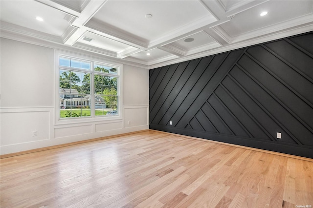 spare room featuring beam ceiling, crown molding, light hardwood / wood-style flooring, and coffered ceiling