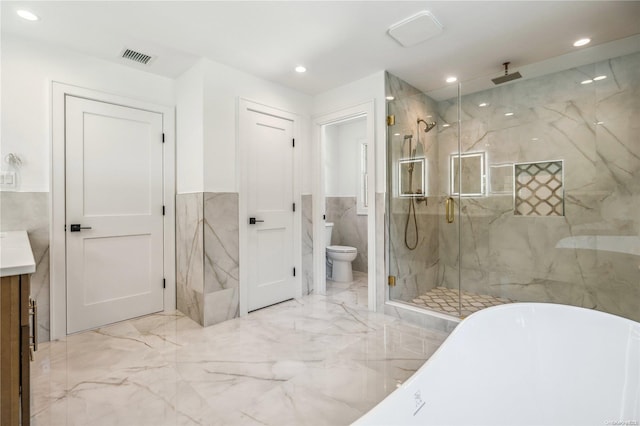 full bathroom with separate shower and tub, vanity, tile walls, and toilet