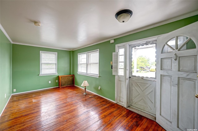 foyer featuring crown molding, radiator heating unit, and hardwood / wood-style floors