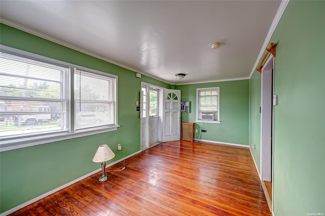 entrance foyer with cooling unit, wood-type flooring, and ornamental molding