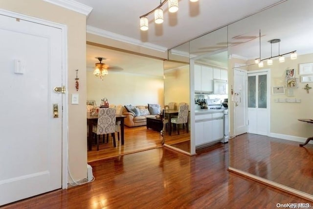 entrance foyer with crown molding, hardwood / wood-style floors, and ceiling fan