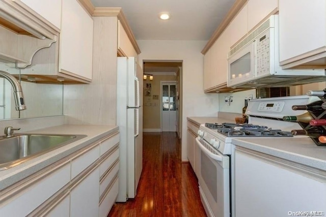 kitchen featuring dark hardwood / wood-style floors, white appliances, and sink