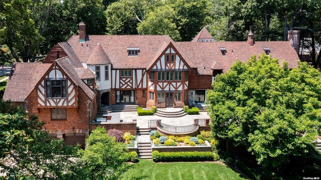 1 Somerset Dr S, Great Neck, NY 11020 - back of property featuring a chimney and brick siding