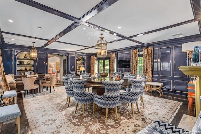 dining area featuring beamed ceiling, wood-type flooring, and coffered ceiling