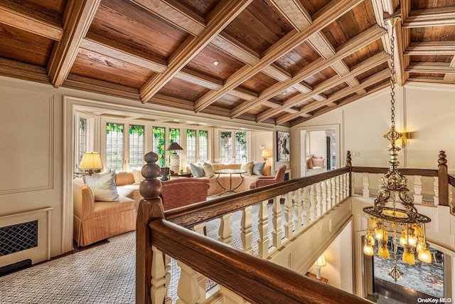 hall with plenty of natural light, lofted ceiling with beams, wood ceiling, and coffered ceiling