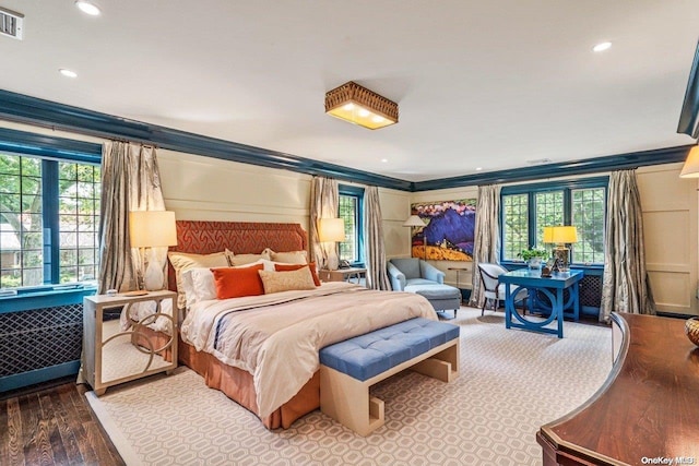 bedroom with crown molding and hardwood / wood-style flooring