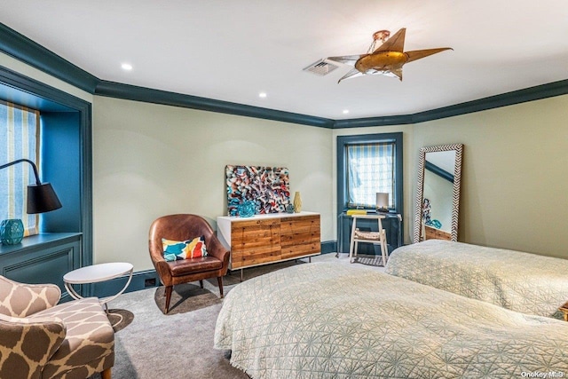 carpeted bedroom with ceiling fan and crown molding