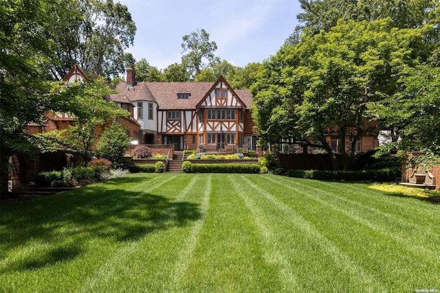 rear view of house with a lawn