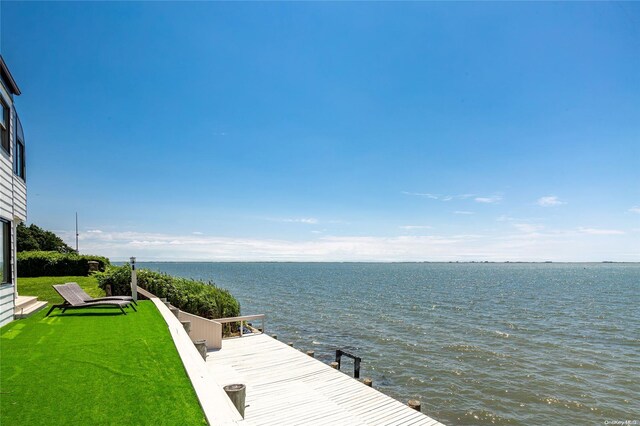 dock area with a water view and a lawn