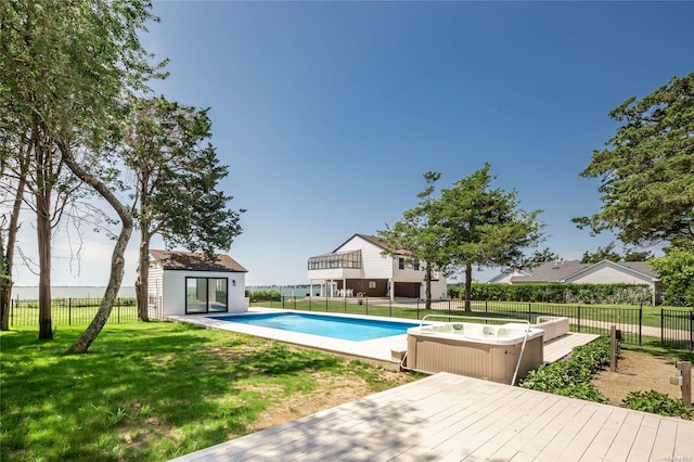 view of pool featuring an outbuilding and a lawn