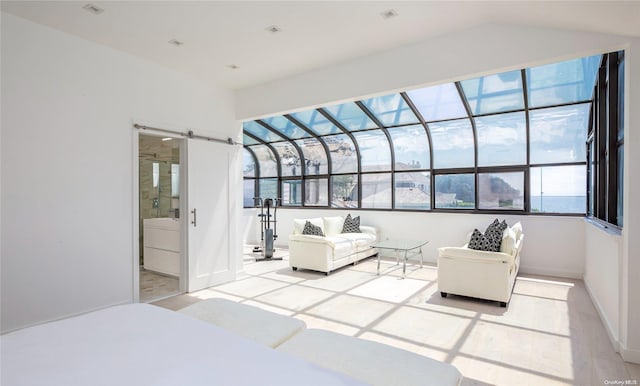 bedroom with multiple windows, ensuite bathroom, and light hardwood / wood-style flooring