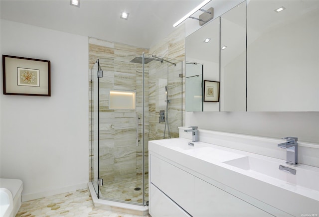 bathroom with vanity and a shower with shower door