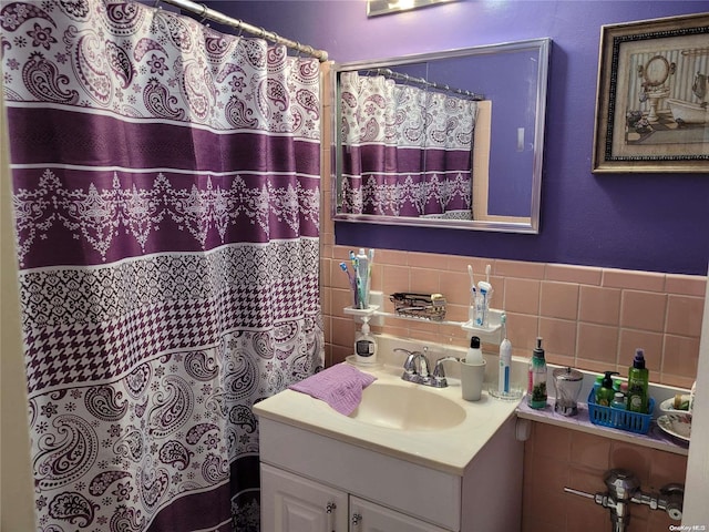 bathroom featuring vanity and tile walls