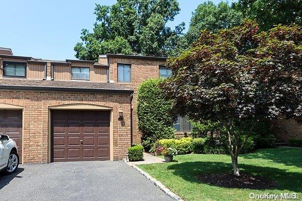 view of front of property with a front lawn and a garage