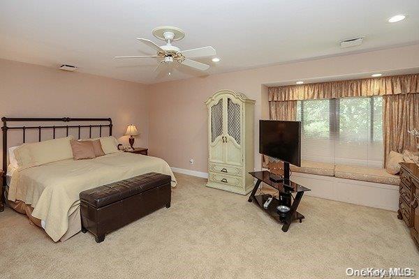 bedroom featuring light colored carpet and ceiling fan