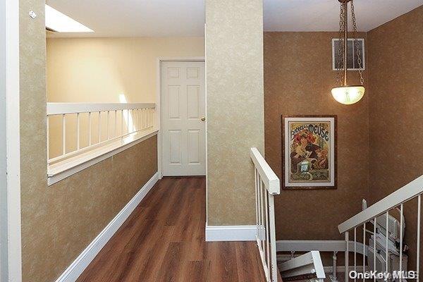 hallway featuring dark hardwood / wood-style floors