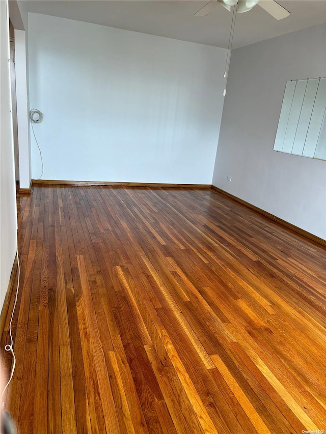 spare room featuring ceiling fan and dark hardwood / wood-style floors