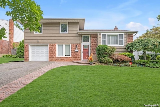 tri-level home featuring a garage and a front yard