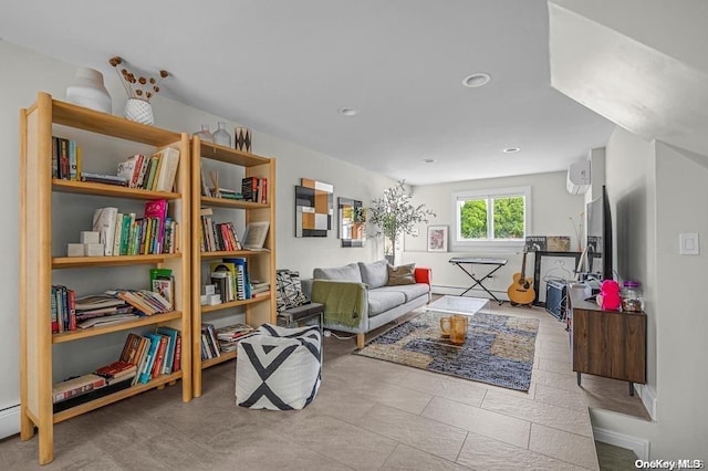 living area featuring a wall unit AC