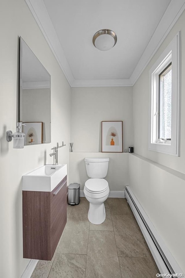 bathroom with vanity, tile patterned flooring, toilet, ornamental molding, and a baseboard radiator