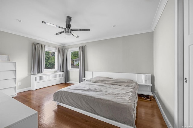 bedroom featuring ceiling fan, hardwood / wood-style floors, and ornamental molding