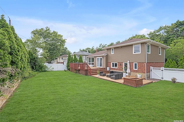 back of property featuring a lawn and a deck