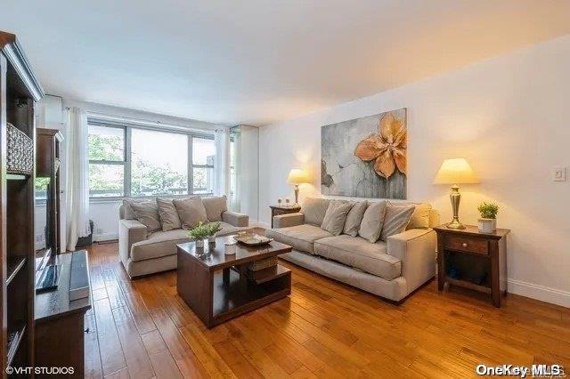 70-25 Yellowstone Blvd Unit 2T, Forest Hills, NY 11375 - living area with hardwood / wood-style floors and baseboards