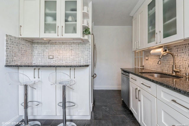70-25 Yellowstone Blvd Unit 2T, Forest Hills, NY 11375 - kitchen featuring dark stone counters, dishwasher, white cabinets, tasteful backsplash, and dark stone finish flooring