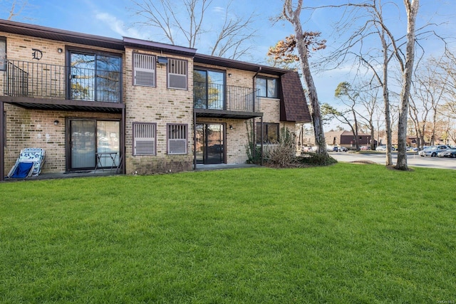 rear view of property featuring a yard