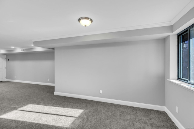 basement featuring dark colored carpet and a wealth of natural light