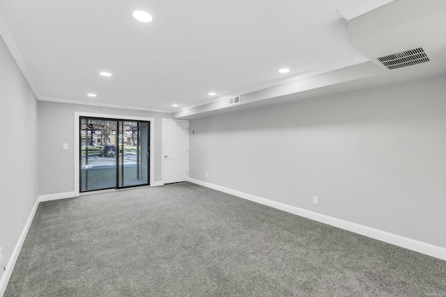 empty room featuring crown molding and carpet