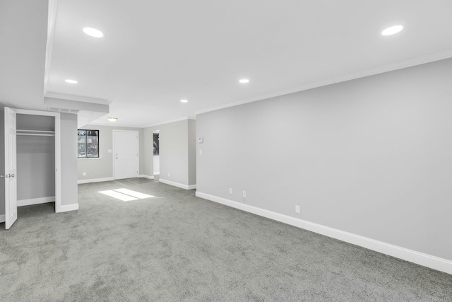 basement featuring crown molding and carpet