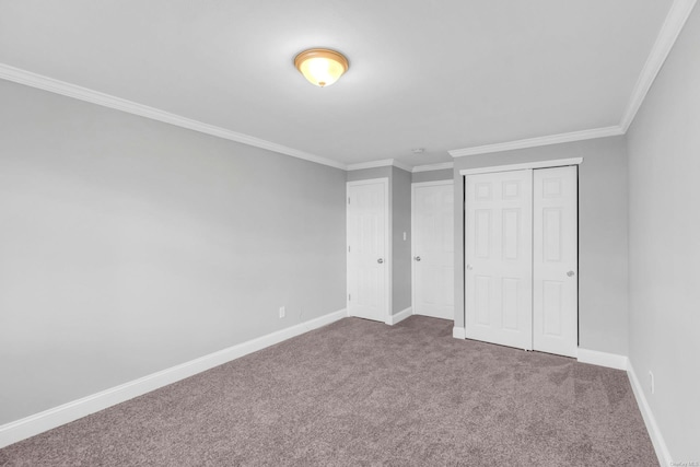 unfurnished bedroom featuring ornamental molding, carpet flooring, and a closet