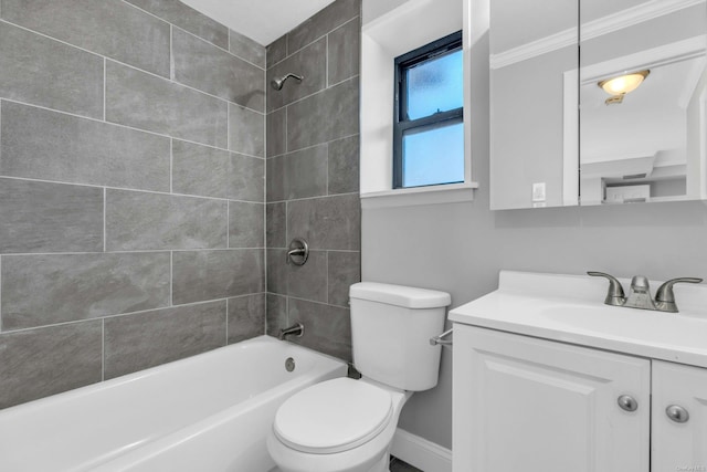 full bathroom with vanity, ornamental molding, tiled shower / bath, and toilet