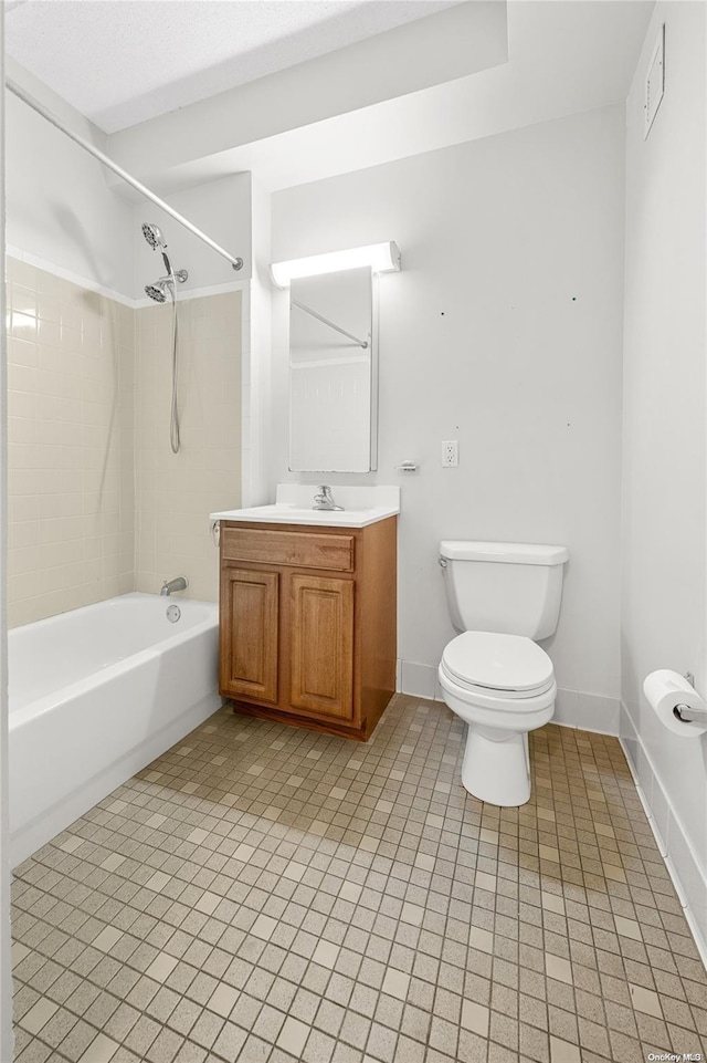 full bathroom featuring tiled shower / bath, tile patterned floors, vanity, and toilet