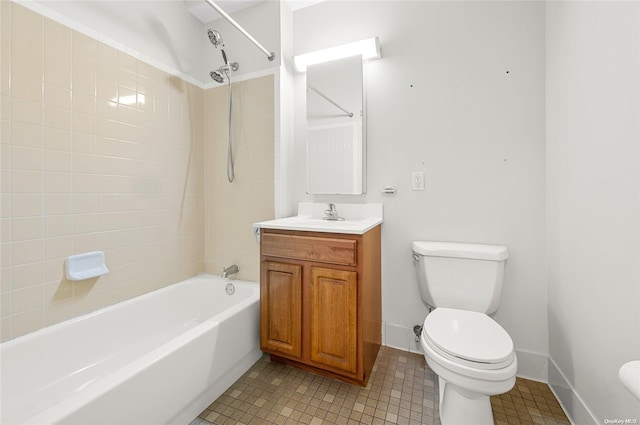 full bathroom featuring vanity, tiled shower / bath combo, and toilet