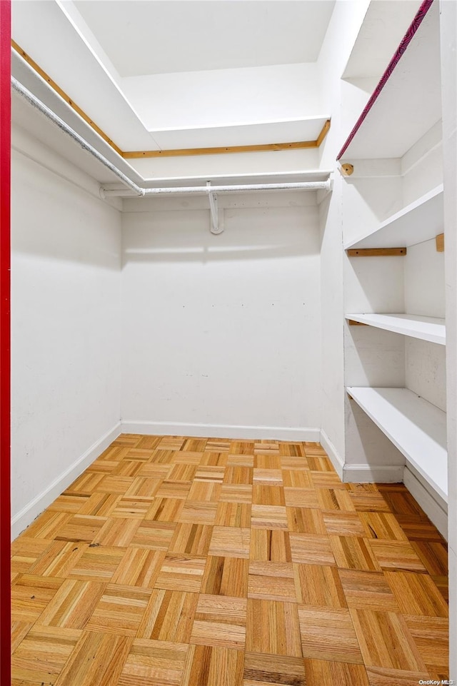 walk in closet featuring light parquet flooring