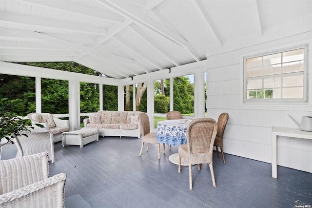 sunroom / solarium with lofted ceiling with beams