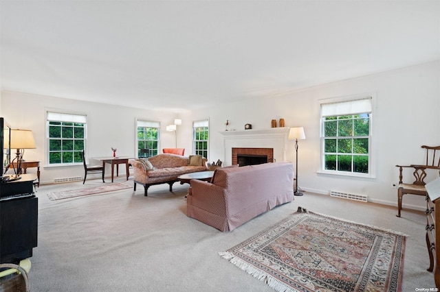 carpeted living room with a brick fireplace