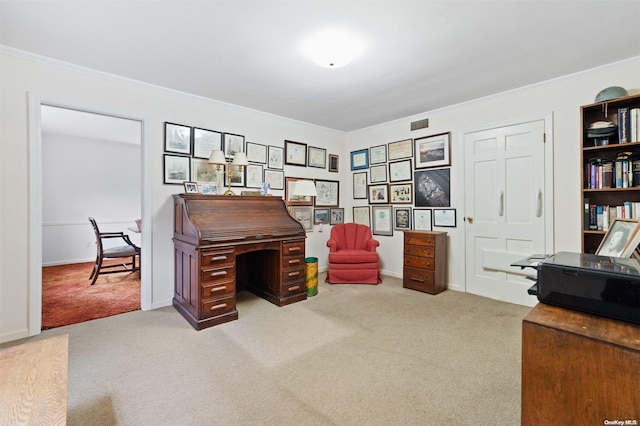 carpeted home office featuring crown molding